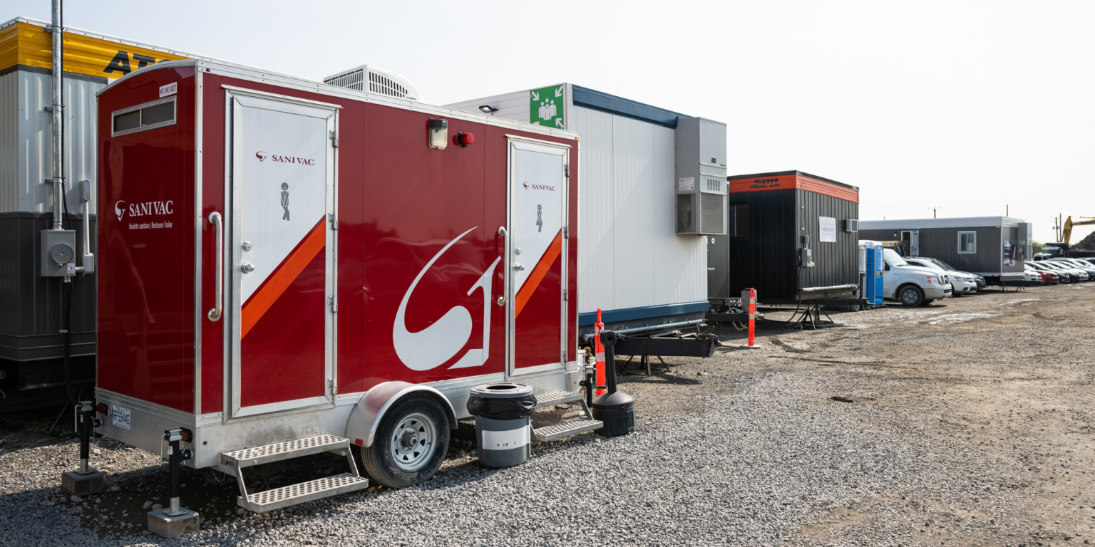 Multisan restroom trailer parked on a construction site